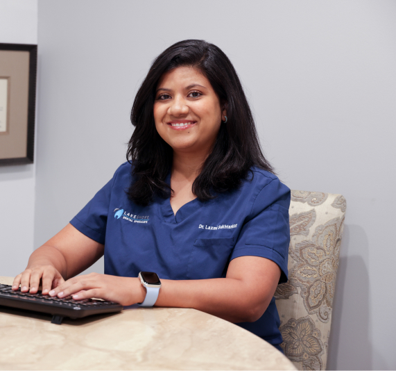 orthodontic and invisalign specialist in detroit sitting at her desk
