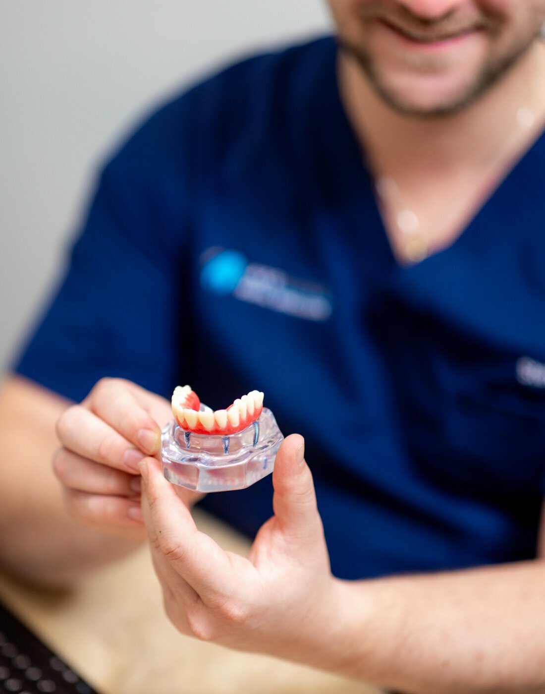 Detroit Dental Staff holding dentures